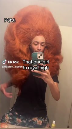 a woman with red hair taking a selfie in the mirror