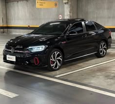 a black car parked in a parking garage