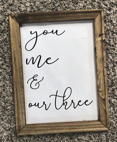 a wooden frame with the words you me and our three written in cursive writing