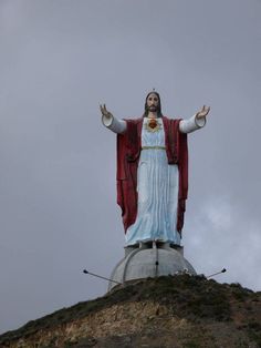 the statue of jesus is on top of a hill