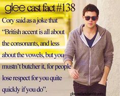 a man with sunglasses on walking down the street in front of a yellow sign that says glee cast 1 8