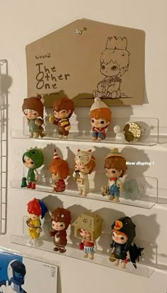some little figurines are sitting on the shelf