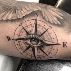 a man's arm with an all seeing eye tattoo on it