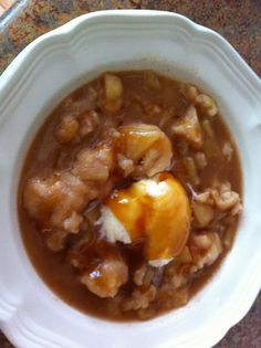 a white bowl filled with food on top of a table
