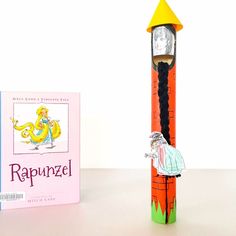 a book and pencil on a table next to an eraser shaped like a dragon