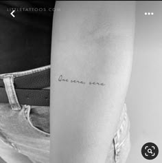 a woman's arm with the words, one more song tattooed on her forearm