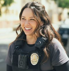 a woman police officer smiles for the camera