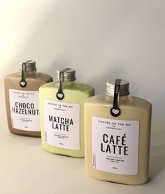 three bottles with labels on them sitting next to each other