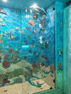 a glass shower door with fish on it
