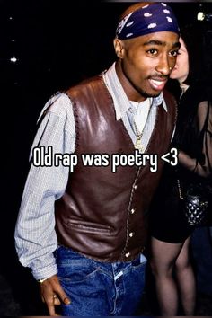 a man wearing a leather vest and bandana standing next to a woman