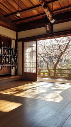 an empty room with wooden floors and sliding glass doors