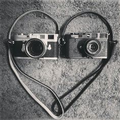two old cameras sitting on top of a carpet