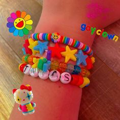 two bracelets with hello kitty charms on the wrist, one for girls and one for boys