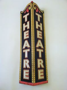 the theatre sign is hanging on the wall