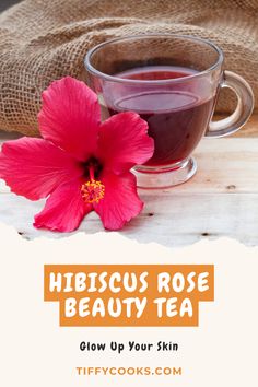 hibiscus rose beauty tea in a glass cup with a pink flower next to it