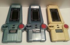 three old nintendo game controllers sitting next to each other