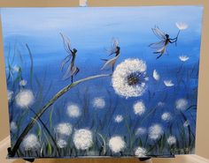 an easel painted with dandelions and white flowers