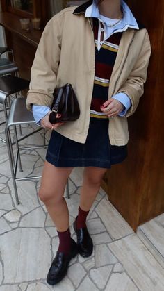 Rugby shirt styling Spring layering Loafer styling  Denim mini skirt Barn jacket Spring colour palette Striped shirt London street style Rugby Shirt And Skirt Outfit, Shirt Jumper, Preppy Cool Style, Blue Shirt Layering, Rugby Shirt Styling, Stylist Work Outfit, Urban Spring Outfits, Style For Spring, Styling A Polo Shirt Women