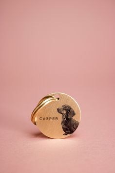 a gold ring with a dog engraved on it's side and the name casper