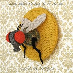 there is a crocheted bee on top of a round object