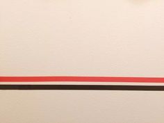 a white wall with red and black lines on it