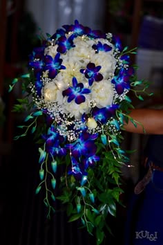 blue and white flowers are arranged in a bouquet