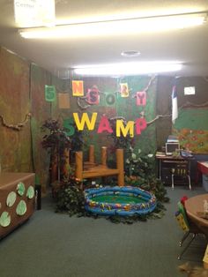 a room decorated with plants and decorations for a children's birthday party