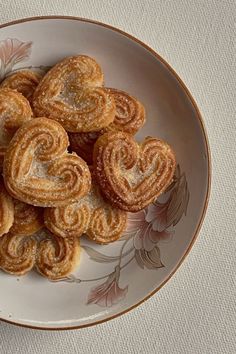 a white plate topped with heart shaped pastries
