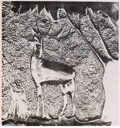 an animal standing next to another animal on a rock