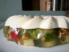 a white plate topped with food covered in icing and toppings on top of it