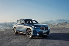 the bmw concept suv is shown in front of mountains