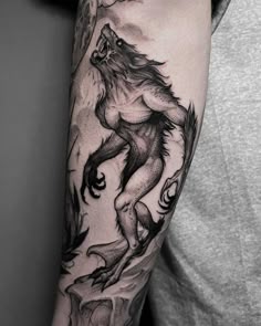 a man with a wolf tattoo on his arm