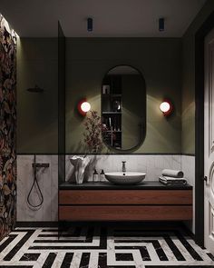 a modern bathroom with black and white tile flooring