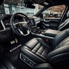 the interior of a car with black leather seats and steering wheel, center console and dashboard