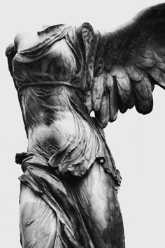 an angel statue is shown in black and white