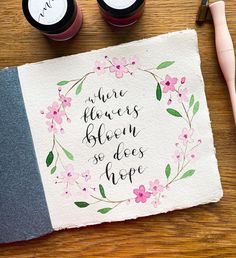 there is a piece of paper with some writing on it and two ink pens next to it