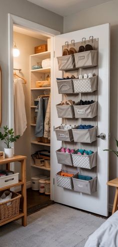 an organized closet is shown with baskets on the door and shelves in front of it