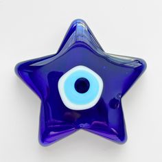 a blue glass star with an evil eye on it