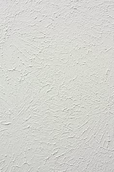a white wall that has been painted with some kind of textured paint on it