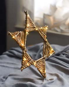 a golden star shaped decoration on top of a bed