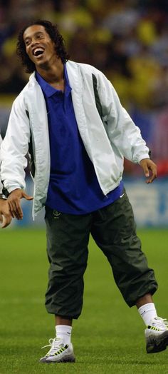 a man is laughing while standing on the field