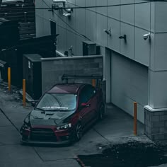 a red car parked in front of a building