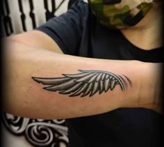 a woman with a black and white tattoo on her arm