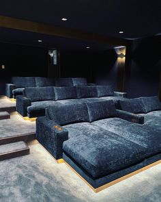 an empty movie theater with blue seats