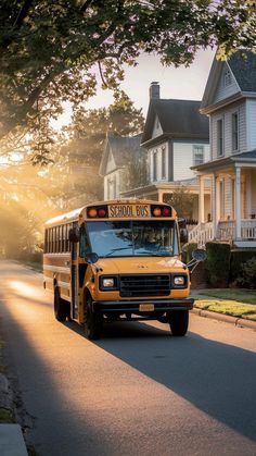 a school bus is driving down the street in front of some houses on a sunny day