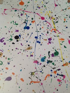 an image of colorful paint splattered on white paper