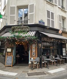the outside of a restaurant with tables and chairs