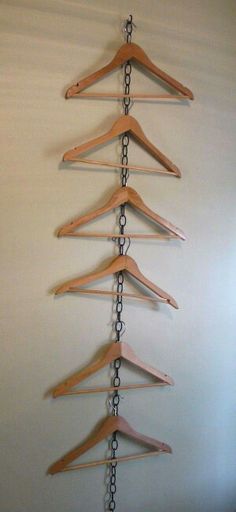 several wooden clothes hangers are hanging on a white wall and there is an instagram post about them