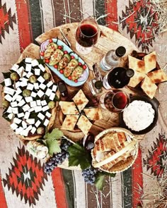 a table topped with lots of food and wine