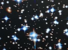 an image of stars in the night sky with bright lights on it's side